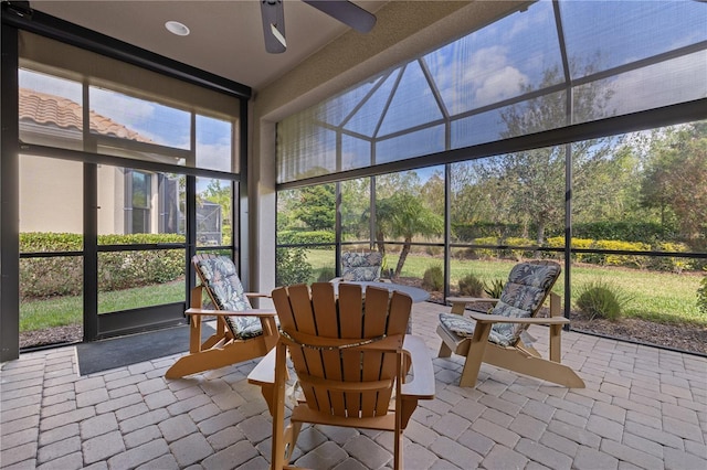 sunroom / solarium featuring ceiling fan