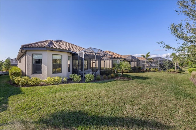 view of yard with glass enclosure