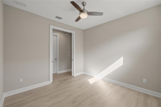 unfurnished room with ceiling fan and light wood-type flooring