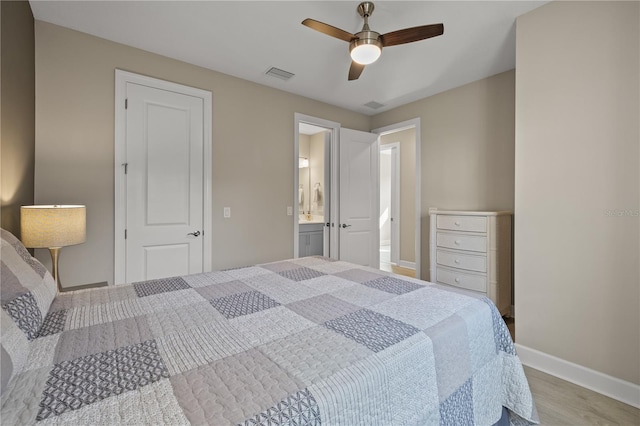 bedroom with connected bathroom, ceiling fan, and light wood-type flooring