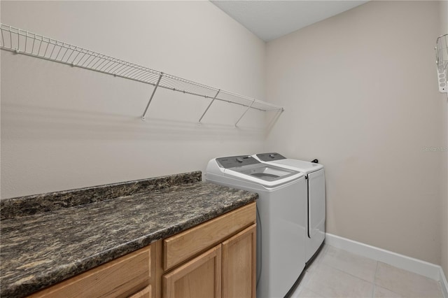 clothes washing area featuring independent washer and dryer and light tile patterned floors