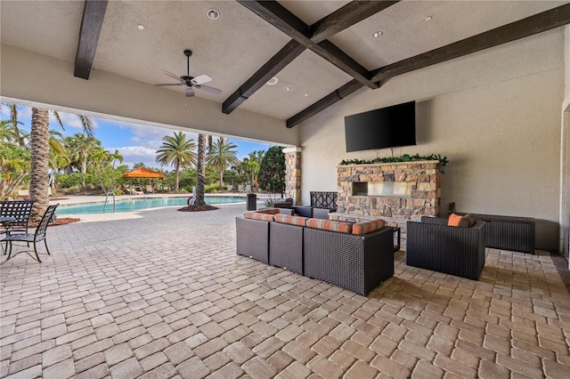 view of patio / terrace featuring an outdoor living space with a fireplace and ceiling fan