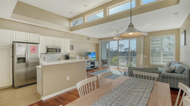 tiled dining space with a towering ceiling