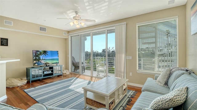 living room featuring ceiling fan and dark hardwood / wood-style flooring