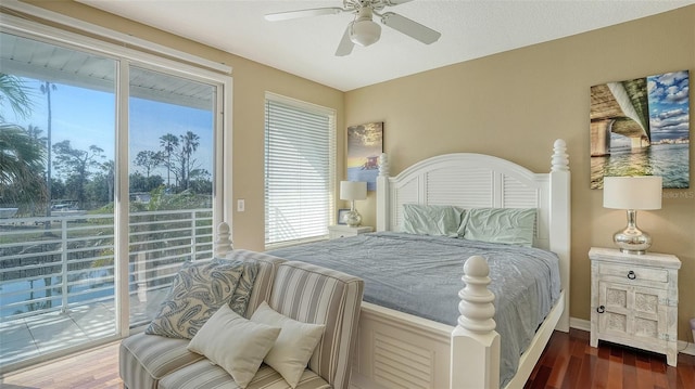 bedroom featuring ceiling fan, dark hardwood / wood-style floors, and access to exterior