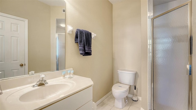 bathroom with toilet, vanity, tile patterned floors, and a shower with door