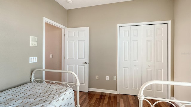 bedroom featuring dark hardwood / wood-style floors and a closet