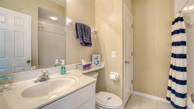 bathroom featuring tile patterned flooring, vanity, and walk in shower