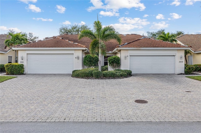 mediterranean / spanish home with a garage