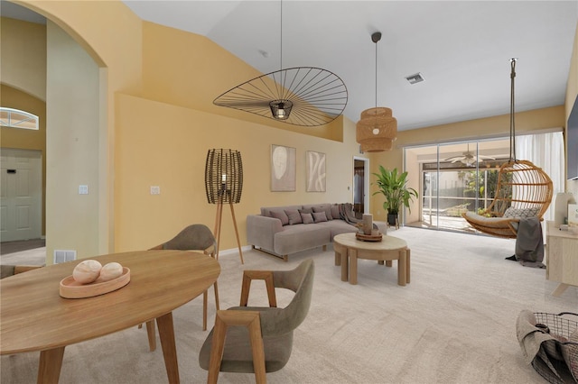 carpeted living room featuring lofted ceiling