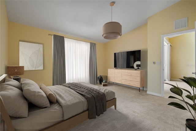 bedroom featuring lofted ceiling and light carpet