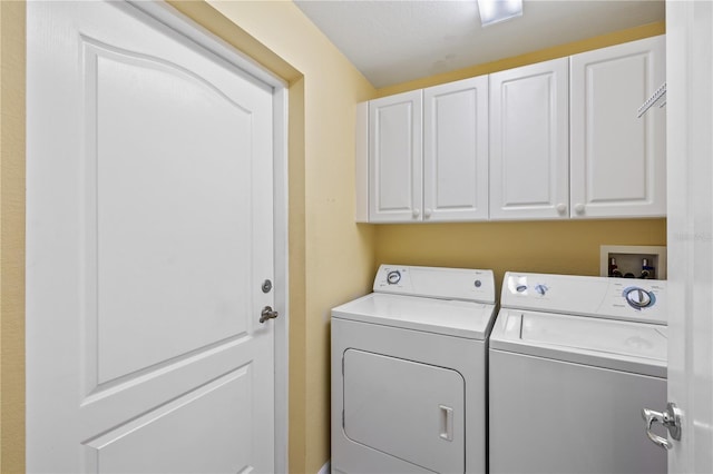 laundry area featuring cabinets and separate washer and dryer