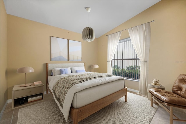 bedroom with lofted ceiling and multiple windows