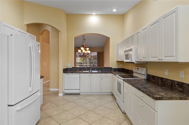 kitchen with white cabinets, white appliances, sink, and light tile patterned floors