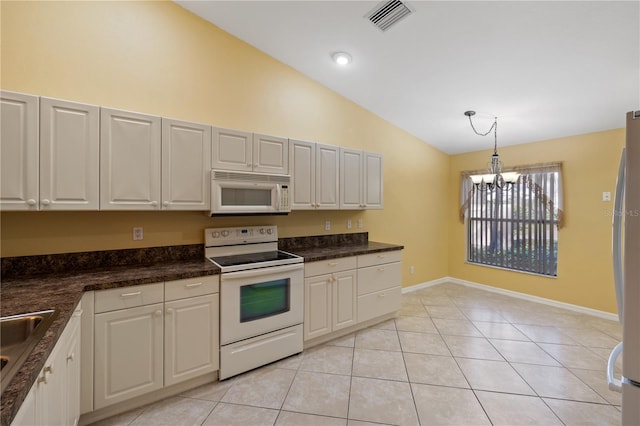 kitchen featuring white cabinetry, hanging light fixtures, and white appliances