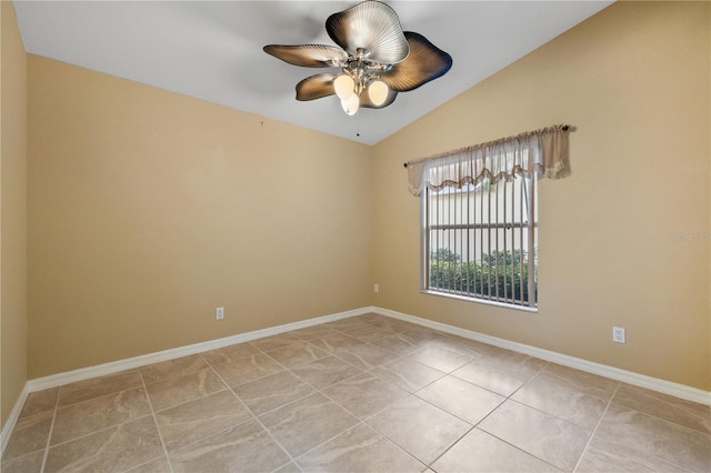 tiled empty room with vaulted ceiling and ceiling fan