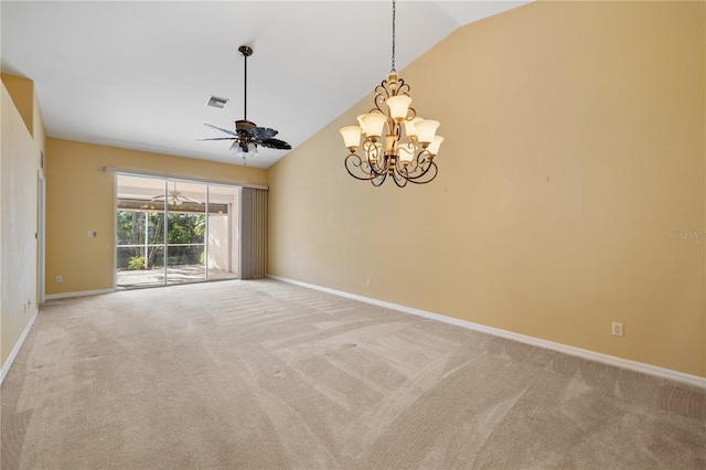 carpeted empty room featuring ceiling fan with notable chandelier and lofted ceiling