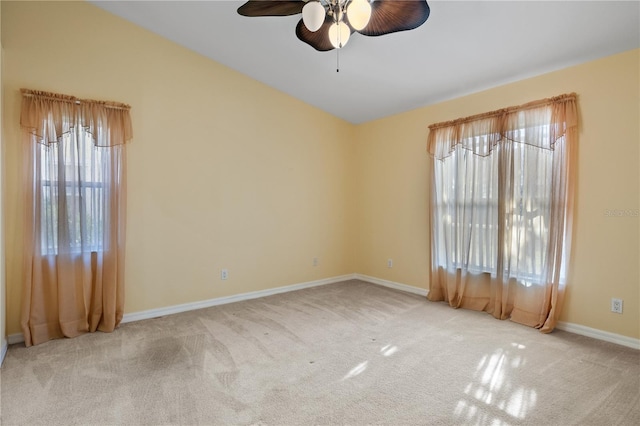 carpeted spare room with ceiling fan