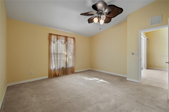 carpeted spare room with ceiling fan and lofted ceiling