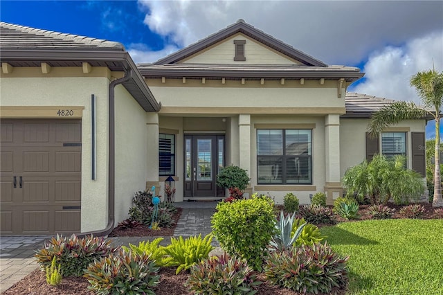 view of exterior entry with a garage