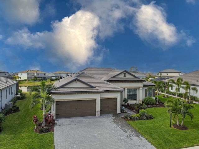 view of front of property with a front lawn and a garage