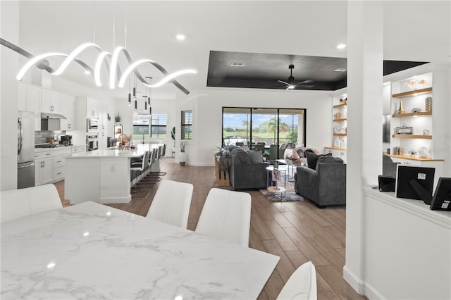 dining area featuring ceiling fan and hardwood / wood-style flooring