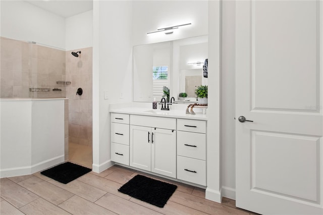 bathroom with vanity and tiled shower