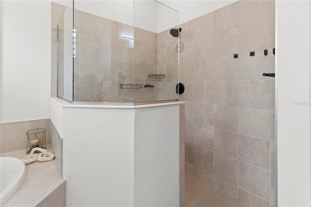 bathroom featuring shower with separate bathtub