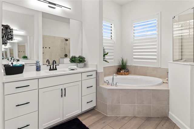 bathroom featuring vanity and separate shower and tub