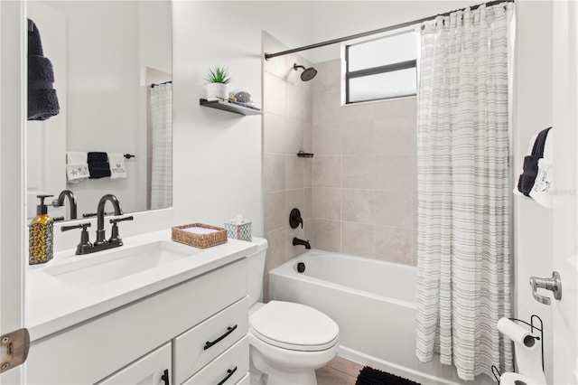 full bathroom featuring shower / bath combo with shower curtain, vanity, and toilet