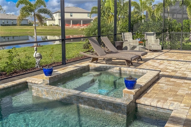 view of swimming pool featuring an in ground hot tub, a patio, and a water view