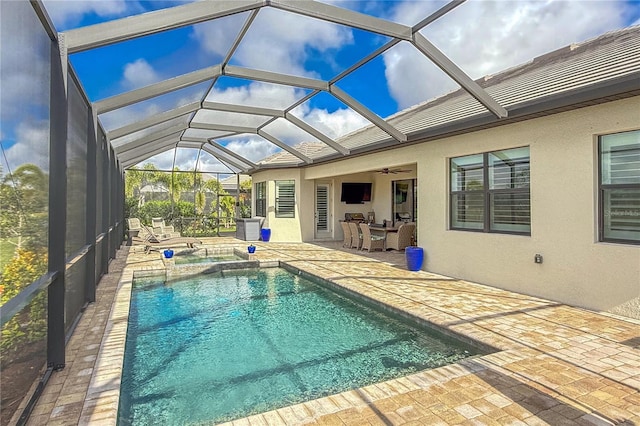 view of pool featuring outdoor lounge area, ceiling fan, a lanai, and a patio