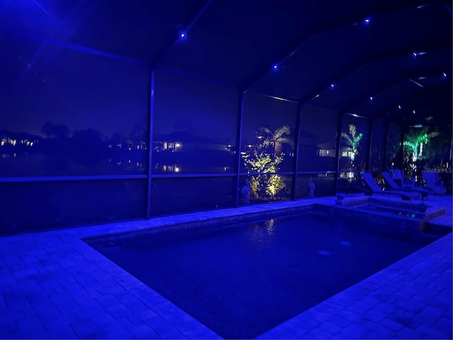 view of pool at twilight