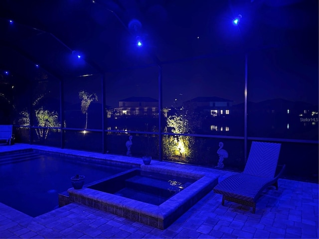 view of pool at night