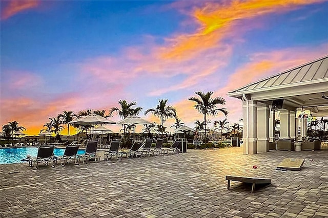 patio terrace at dusk with a community pool