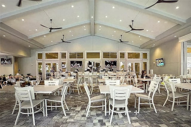 carpeted dining area featuring beamed ceiling and high vaulted ceiling