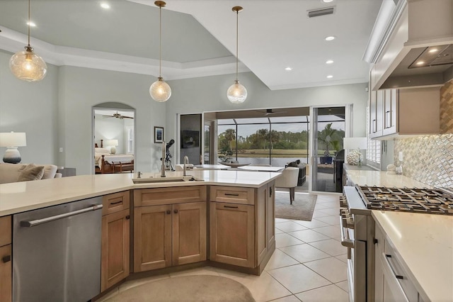 kitchen with stainless steel appliances, sink, ceiling fan, hanging light fixtures, and premium range hood