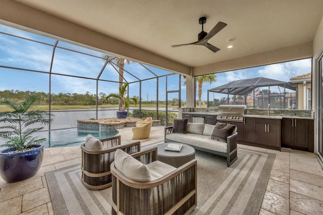 view of patio featuring sink, an outdoor hangout area, a water view, area for grilling, and exterior kitchen