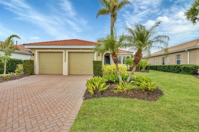 mediterranean / spanish-style house featuring a front lawn and a garage