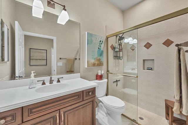 bathroom with a shower with shower door, vanity, and toilet