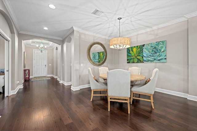 dining space with dark hardwood / wood-style flooring, a notable chandelier, and ornamental molding