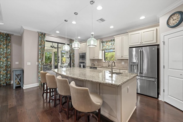 12606 Fontana Loop, Bradenton, FL 34211 - kitchen featuring stainless steel appliances, ornamental molding, a center island with sink, dark wood-style flooring, and decorative backsplash
