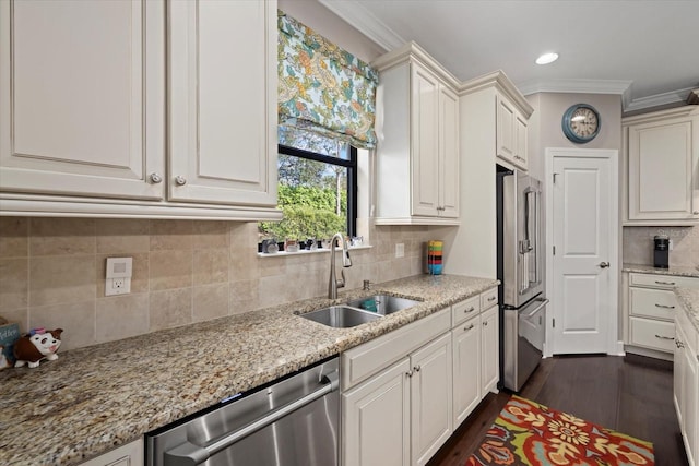 12606 Fontana Loop, Bradenton, FL 34211 - kitchen with appliances with stainless steel finishes, crown molding, tasteful backsplash, light stone counters, and dark wood-style flooring