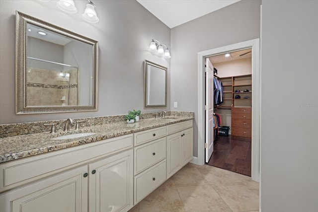 12606 Fontana Loop, Bradenton, FL 34211 - full bathroom with a stall shower, double vanity, a walk in closet, and tile patterned flooring