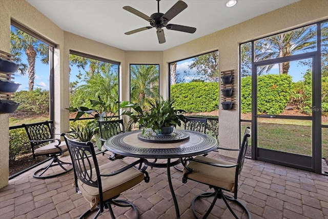 sunroom / solarium featuring ceiling fan