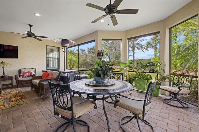 sunroom / solarium featuring ceiling fan and plenty of natural light