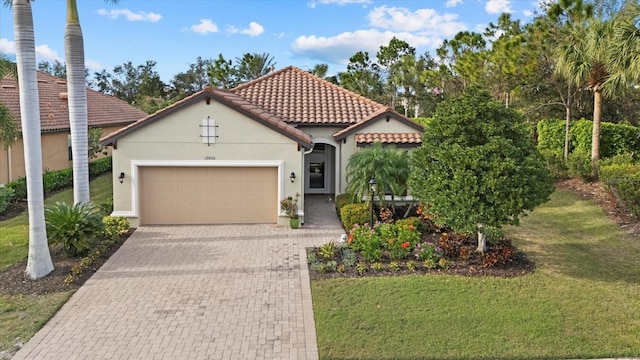 12606 Fontana Loop, Bradenton, FL 34211 - mediterranean / spanish house with stucco siding, a front lawn, a garage, a tiled roof, and decorative driveway