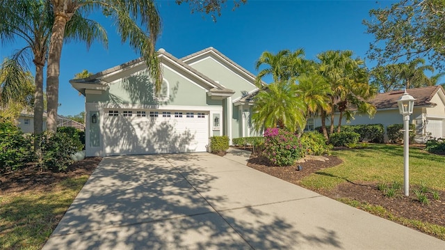 view of front facade featuring a front lawn and a garage