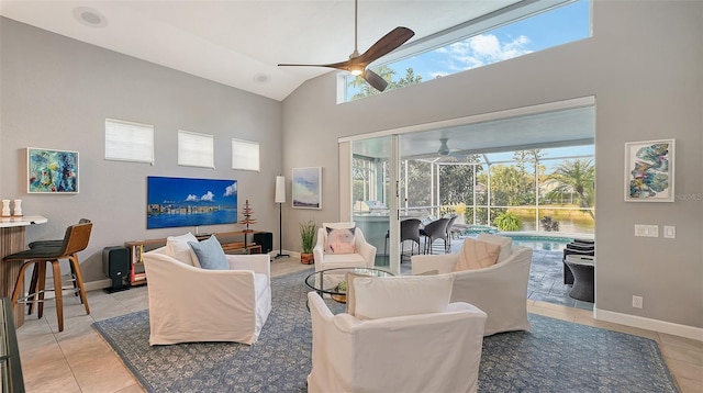 tiled living room with lofted ceiling, ceiling fan, and a healthy amount of sunlight