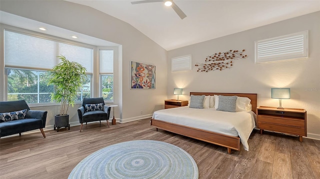 bedroom with ceiling fan, lofted ceiling, and hardwood / wood-style floors